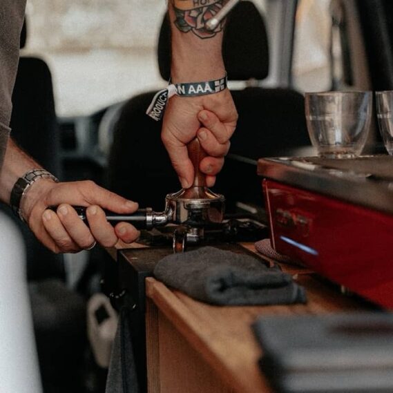 A barista tamping coffee